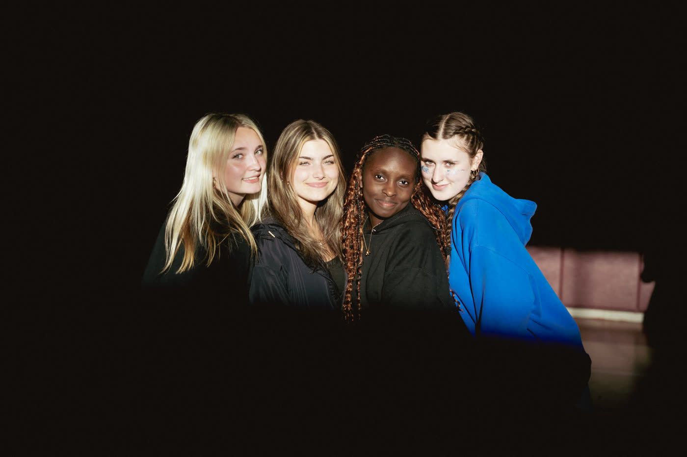 Four friends posing together